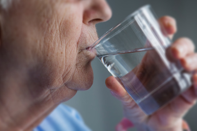 Senior man drinking water